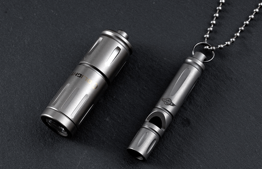 This image shows a keychain flashlight and titanium whistle.